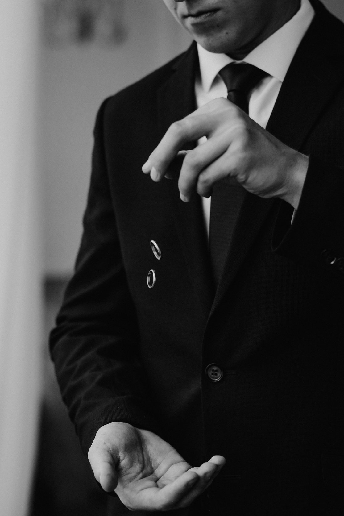 Man in Suit Dropping Wedding Rings